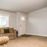 Skyline Homes Westridge 1216CT Manufactured Home Living room featuring large windows and carpet flooring