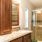 Skyline Homes Westridge 1216CT Manufactured Home Master bathroom featuring double vanity, linen cabinet, shower, small window, toilet