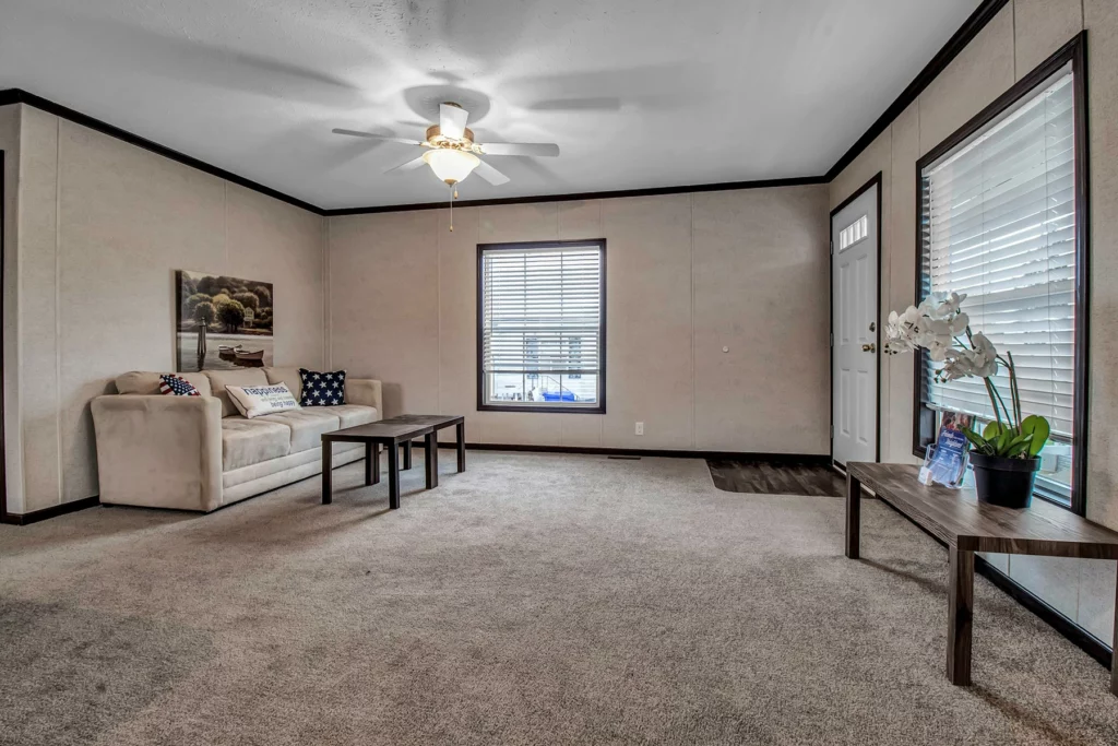 Skyline Homes Arlington 2289P Manufactured Home Living room featuring large windows and carpet flooring