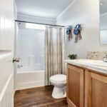 Skyline Homes Arlington G561 Manufactured Home Second bathroom featuring shower bath, single vanity, toilet