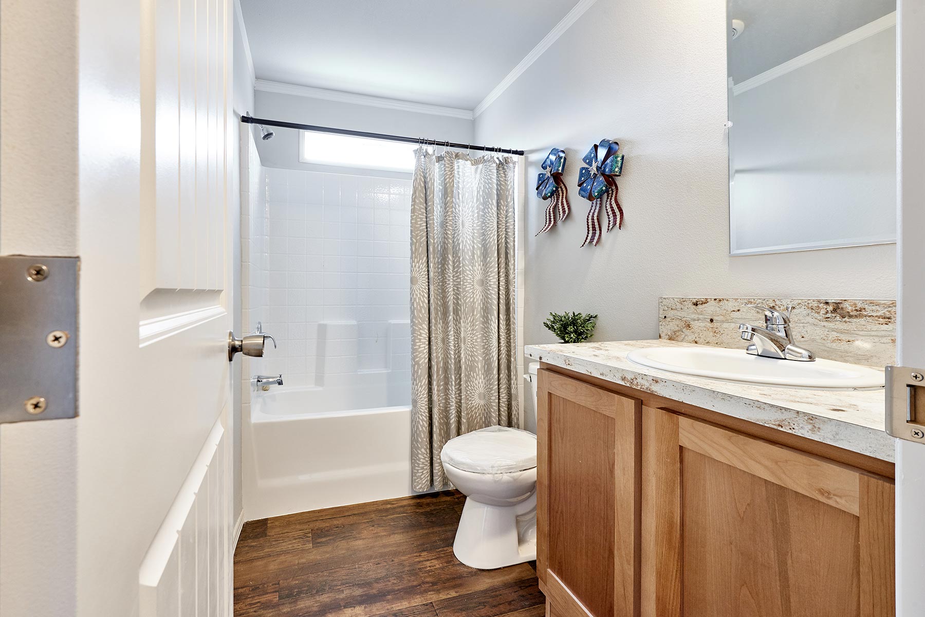 Skyline Homes Arlington G561 Manufactured Home Second bathroom featuring shower bath, single vanity, toilet
