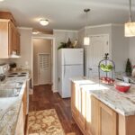 Skyline Homes Arlington G561 Manufactured Home Kitchen featuring island, appliances, small window