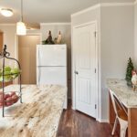 Skyline Homes Arlington G561 Manufactured Home Kitchen featuring island, appliances, small window