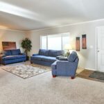 Skyline Homes Arlington G561 Manufactured Home Living room featuring large window and carpet flooring