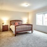 Skyline Homes Arlington G561 Manufactured Home Master bedroom featuring large window and carpet flooring
