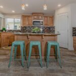 Skyline Homes Westridge 1473CT Manufactured Home Kitchen featuring island, walk-in pantry, appliances, small windows