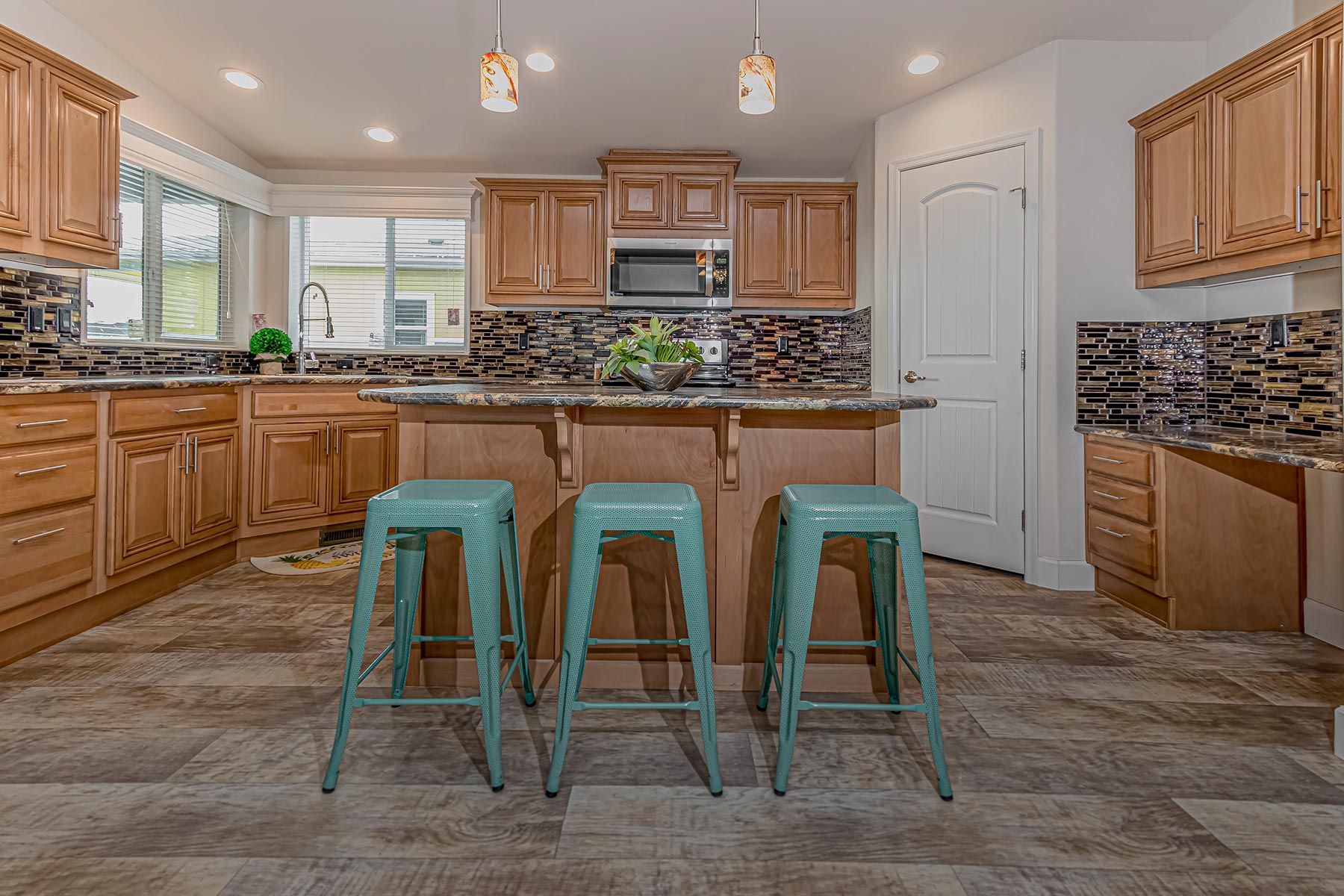 Skyline Homes Westridge 1473CT Manufactured Home Kitchen featuring island, walk-in pantry, appliances, small windows