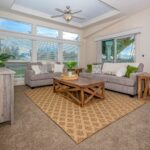 Skyline Homes Westridge 1473CT Manufactured Home featuring large windows, ceiling fan, carpet flooring
