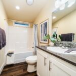 Skyline Homes Westridge 1492CT Manufactured Home Second bathroom featuring single vanity, shower bath, toilet