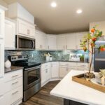 Skyline Homes Westridge 1492CT Manufactured Home Kitchen featuring island, appliances, pantry