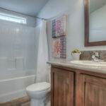 Skyline Homes Westridge 1222CT Manufactured Home Second bathroom featuring single vanity, shower bath, toilet