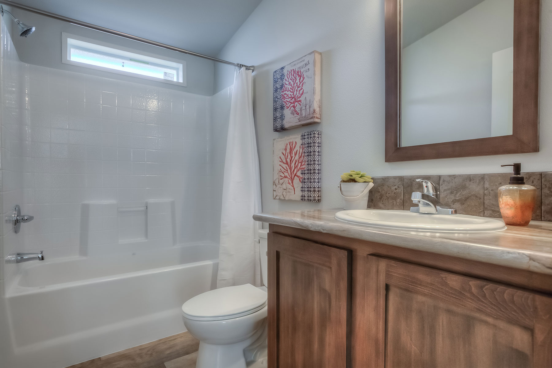 Skyline Homes Westridge 1222CT Manufactured Home Second bathroom featuring single vanity, shower bath, toilet