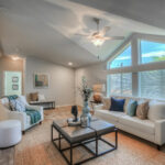 Skyline Homes Westridge 1222CT Manufactured Home Living room featuring ceiling fan, vaulted ceiling, large windows