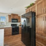 Skyline Homes Westridge 1227CT Manufactured Home Kitchen featuring island, appliances, small window, pantry