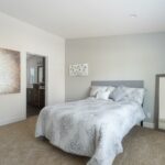 Skyline Homes Westridge 1227CT Manufactured Home Master bedroom featuring walk-in closet, carpet flooring, large window