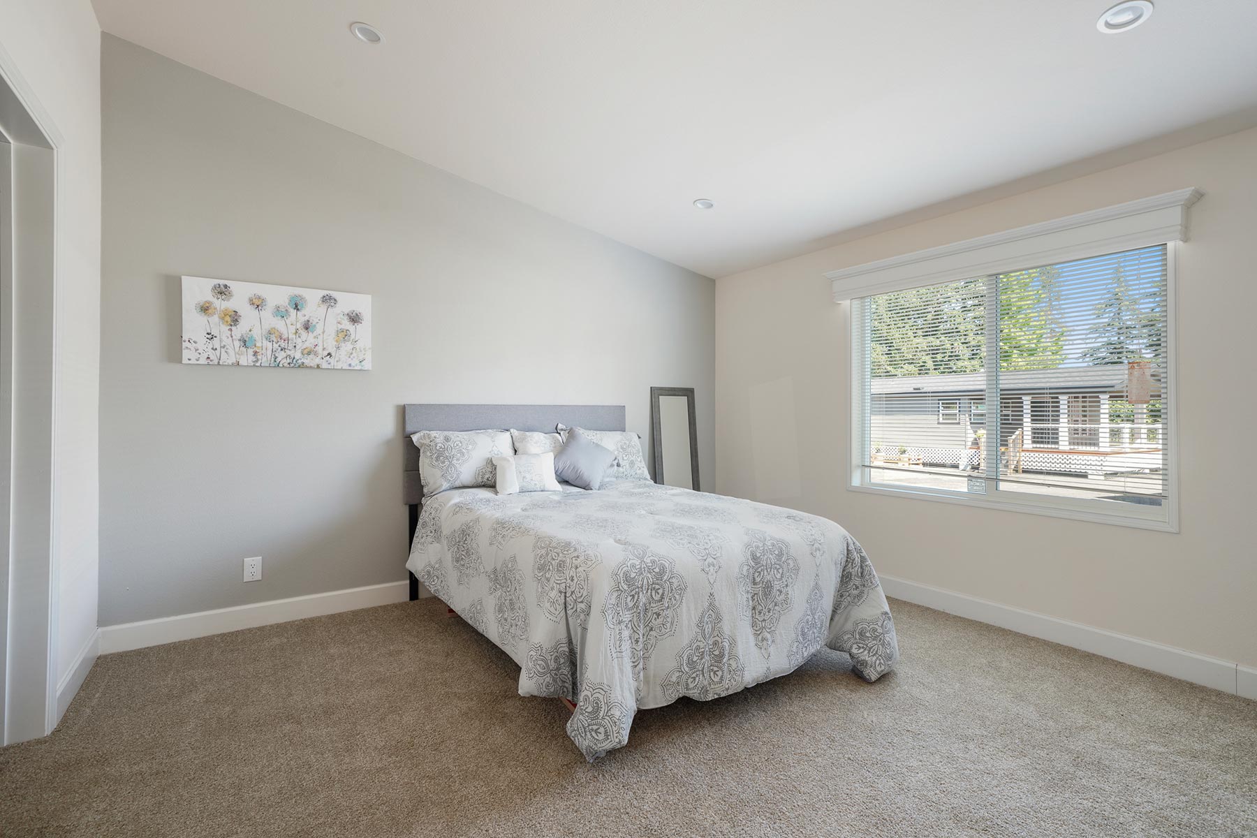 Skyline Homes Westridge 1227CT Manufactured Home Master bedroom featuring walk-in closet, carpet flooring, large window