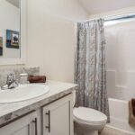 Skyline Homes Westridge 1265CT Manufactured Home Second bathroom featuring shower bath, single vanity, toilet