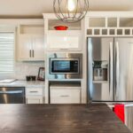 Skyline Homes Westridge 1265CT Manufactured Home Kitchen featuring island, walk-in pantry, appliances, small window