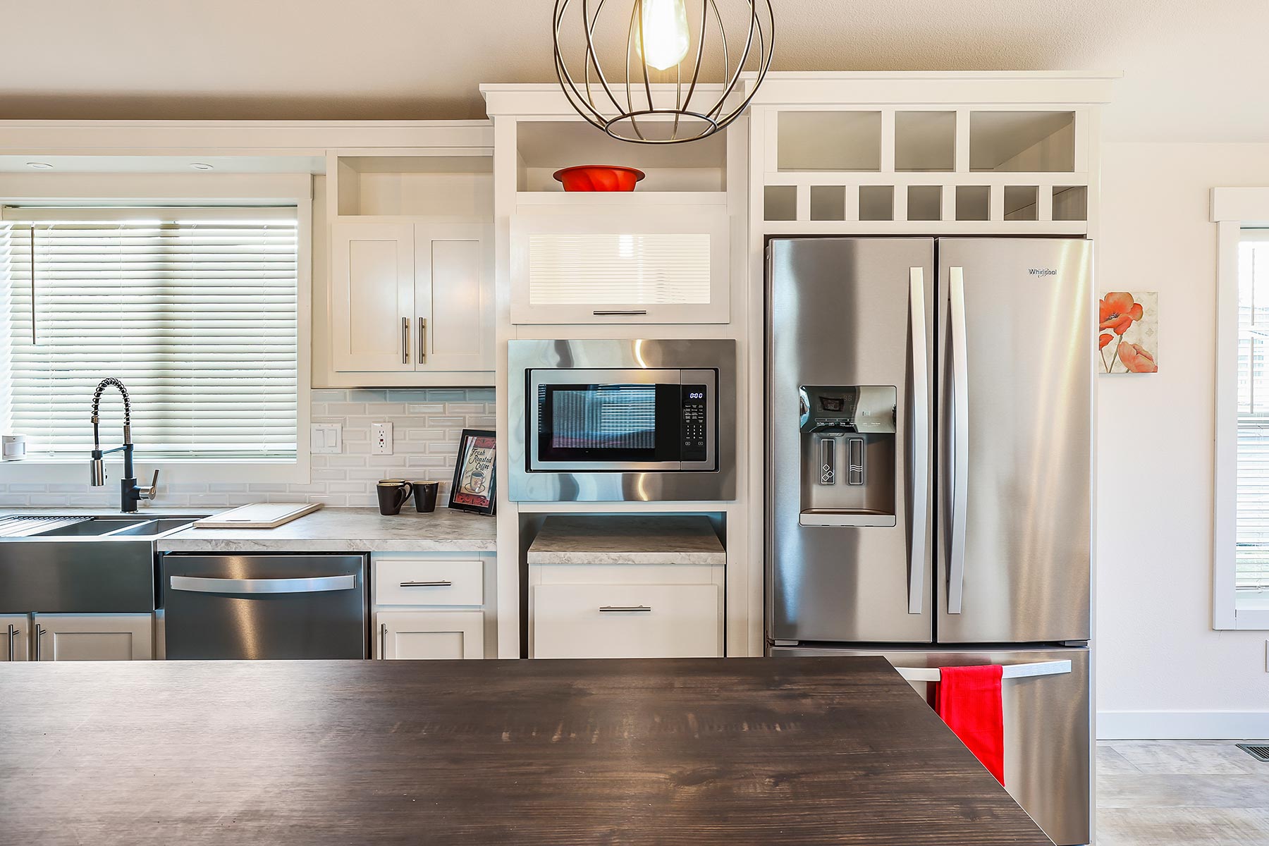 Skyline Homes Westridge 1265CT Manufactured Home Kitchen featuring island, walk-in pantry, appliances, small window
