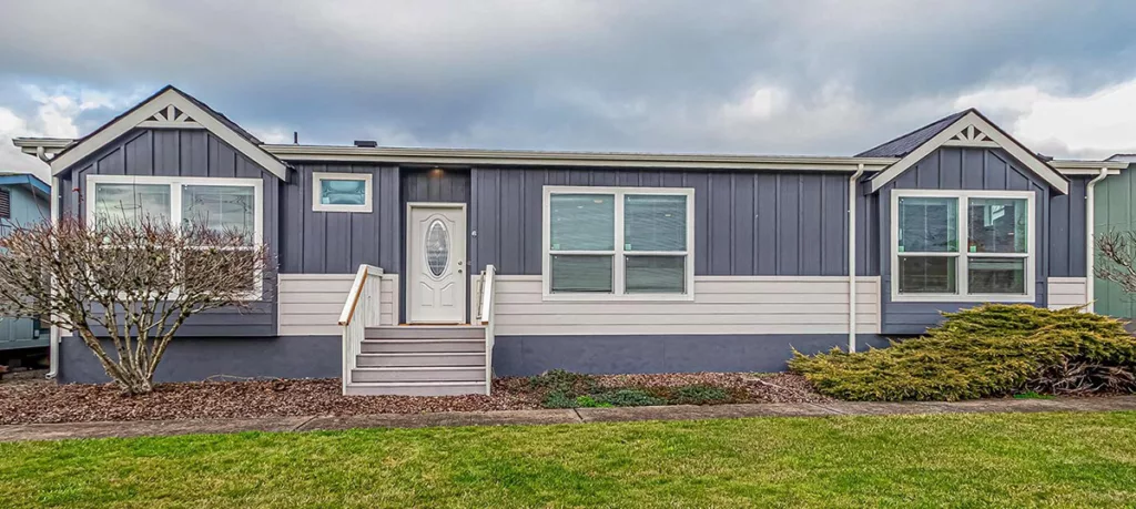 Blue-gray manufactured home with off-white accents and batten and board siding