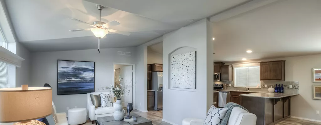 ceiling fan mounted over sitting area in manufactured home living room