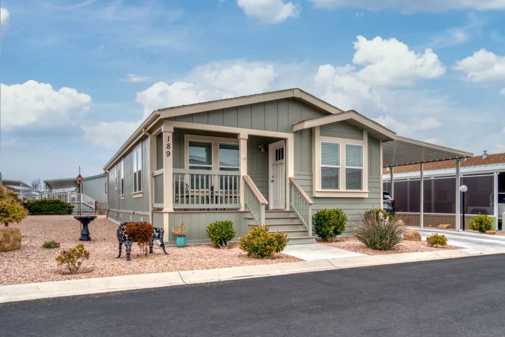 manufactured home with front porch and covered parking spot