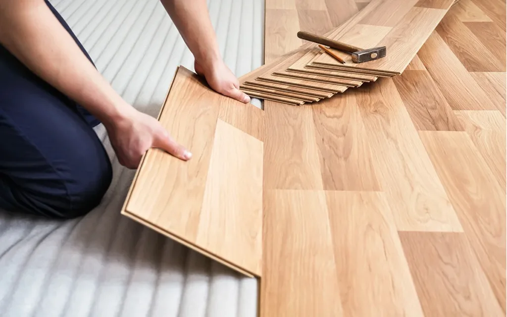 Installing laminate wood flooring during the manufactured home construction process