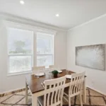 dining nook with windows looking out over the front lawn