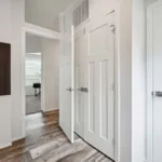 hallway with linen closet that leads to a bedroom and bathroom