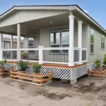 covered wraparound porch with iron railing, recessed lighting, and short stairway