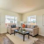 front door opening into the living room with large front window overlooking the front lawn