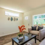 front door opening into the living room with large front window overlooking the front lawn