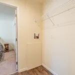 walk-in closet with hardwood flooring