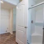 secondary bathroom with standing shower and single sink granite counter