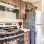 open kitchen with granite counters, stainless steel appliances, and dark wood cabinets