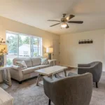 a spacious living room leading to the primary bedroom