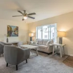 a spacious living room closed off from the kitchen and dining nook