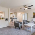 a spacious living room closed off from the kitchen and dining nook